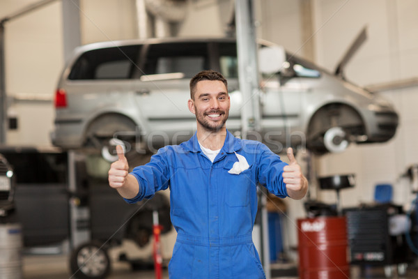 happy auto mechanic man or smith at car workshop Stock photo © dolgachov