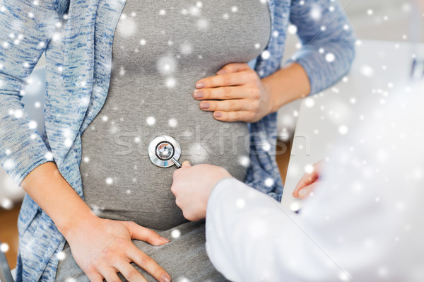 Stock photo: doctor with stethoscope and pregnant woman belly