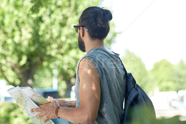 close up of man with backpack and map in city Stock photo © dolgachov