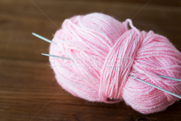 knitting needles and ball of pink yarn on wood Stock photo © dolgachov