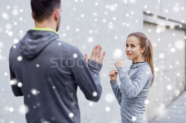 happy woman with coach working out strike outdoors Stock photo © dolgachov