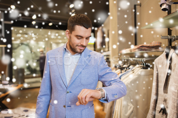 happy man in jacket with watch at clothing store Stock photo © dolgachov