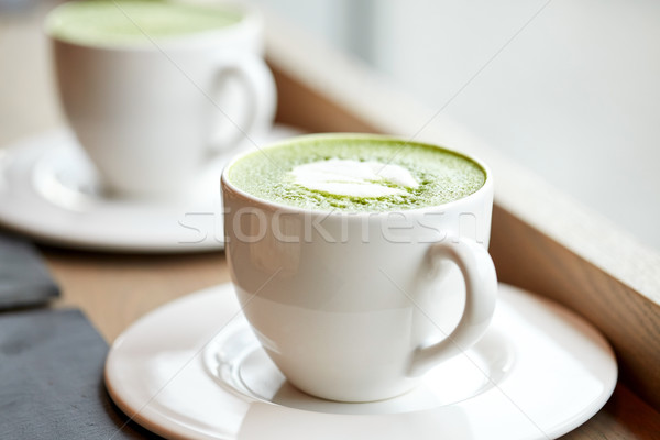 white cup of matcha green tea latte on table Stock photo © dolgachov