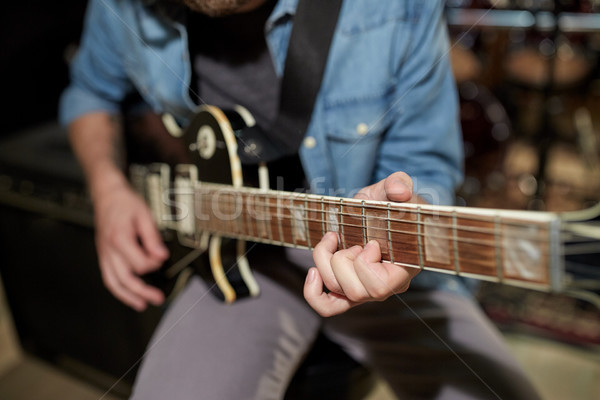 man playing guitar at studio rehearsal Stock photo © dolgachov