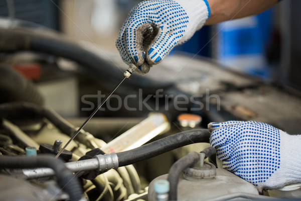 mechanic with dipstick checking motor oil level Stock photo © dolgachov