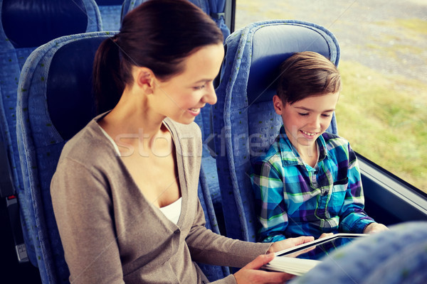 happy family with tablet pc sitting in travel bus Stock photo © dolgachov