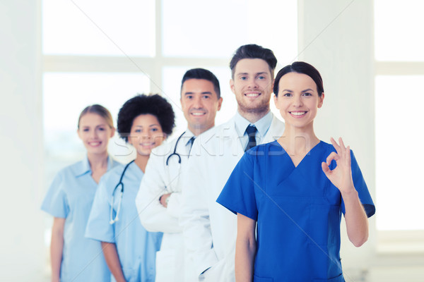 group of happy doctors at hospital Stock photo © dolgachov