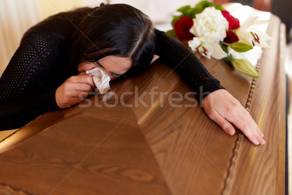 Stock photo: woman with coffin crying at funeral in church