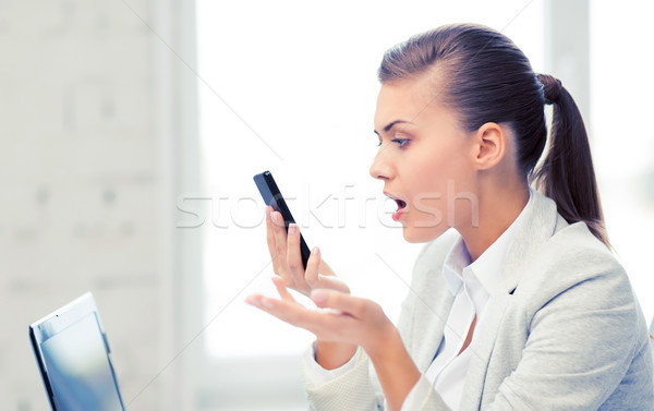 Stock photo: woman shouting into smartphone