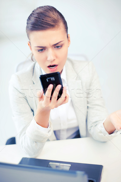woman shouting into smartphone Stock photo © dolgachov
