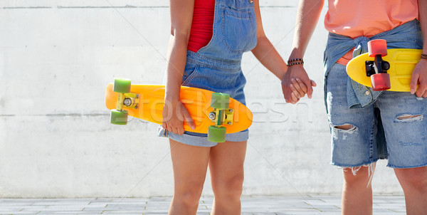 close up of young couple with skateboards outdoors Stock photo © dolgachov