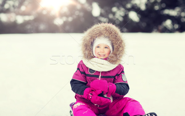 happy little kid on sled outdoors in winter Stock photo © dolgachov