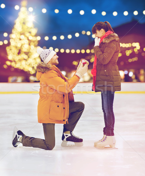 couple with engagement ring at xmas skating rink Stock photo © dolgachov