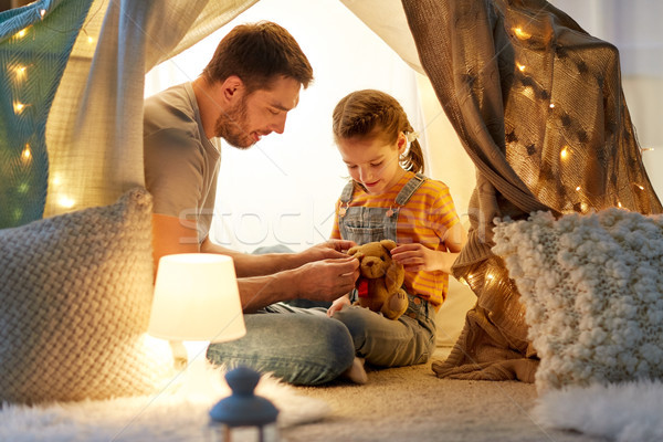 happy family playing with toy in kids tent at home Stock photo © dolgachov