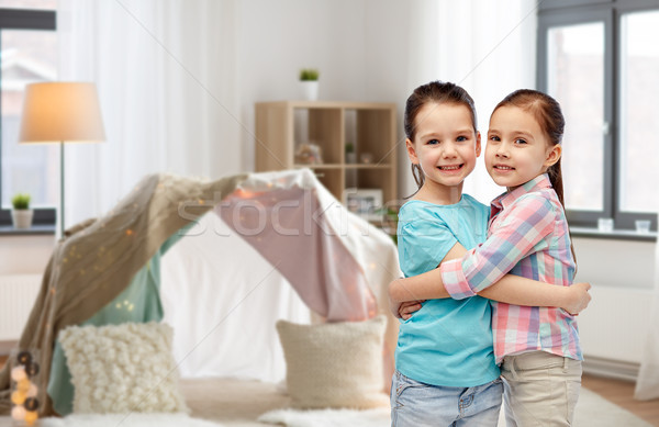 happy smiling little girls hugging at home Stock photo © dolgachov