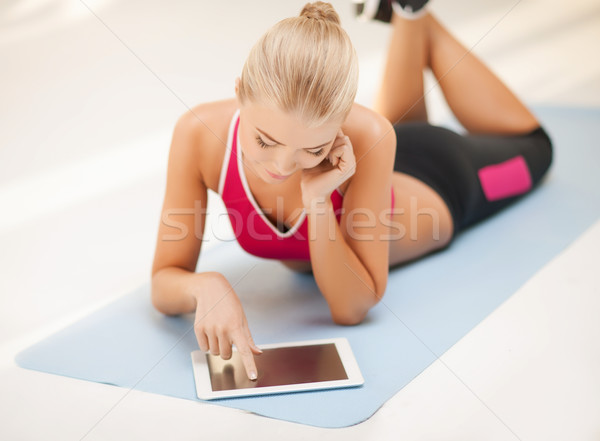 woman lying on the floor with tablet pc Stock photo © dolgachov