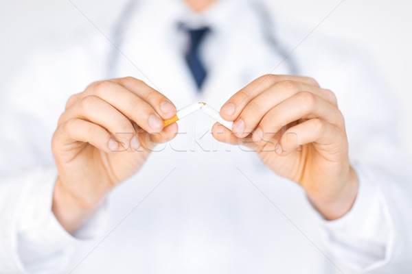 man breaking the cigarette with hands Stock photo © dolgachov