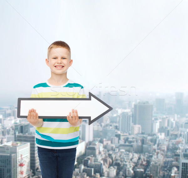 smiling little boy with blank arrow pointing right Stock photo © dolgachov