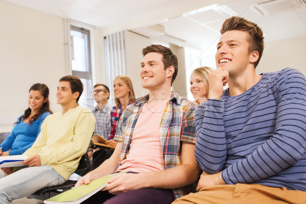 group of smiling students in lecture hall Stock photo © dolgachov