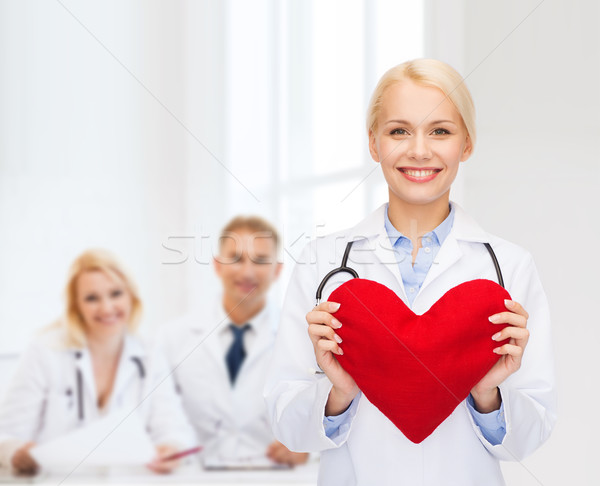smiling female doctor with heart and stethoscope Stock photo © dolgachov