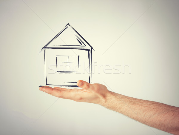 house on virtual screen in man hand Stock photo © dolgachov