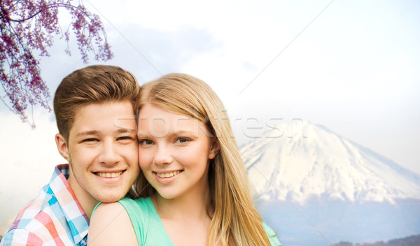 smiling couple hugging over fuji mountain in japan Stock photo © dolgachov