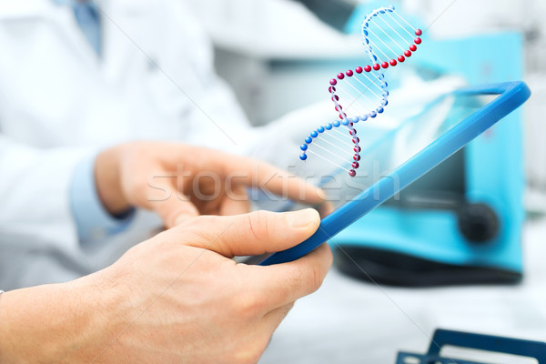 Stock photo: close up of scientists hands with tablet pc in lab