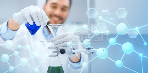 Stock photo: close up of scientist with test tubes and funnel