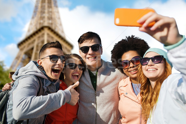 Stock photo: smiling friends taking selfie with smartphone