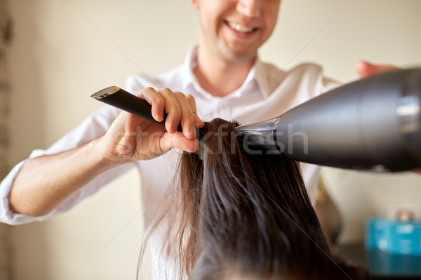  close up of stylist making hairdo at salon Stock photo © dolgachov