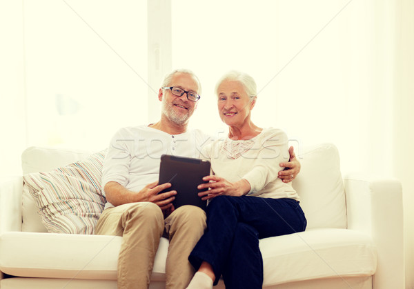 happy senior couple with tablet pc at home Stock photo © dolgachov