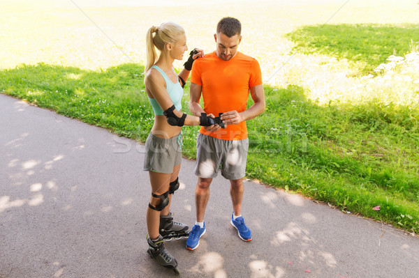happy couple with roller skates riding outdoors Stock photo © dolgachov