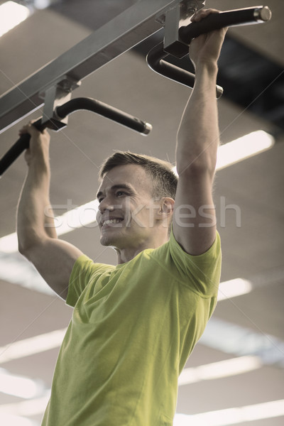 smiling man exercising in gym Stock photo © dolgachov