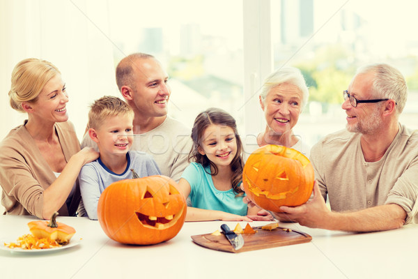 happy family sitting with pumpkins at home Stock photo © dolgachov