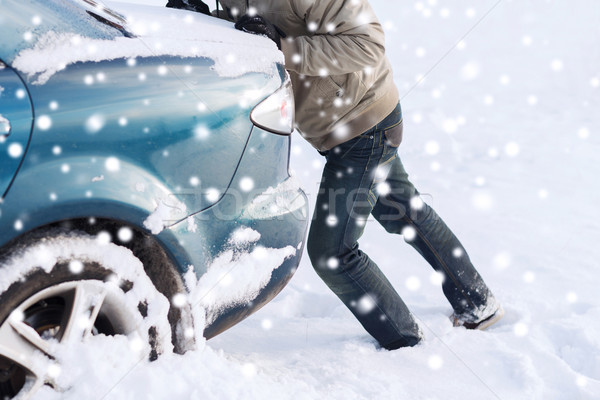 closeup of man pushing car stuck in snow Stock photo © dolgachov