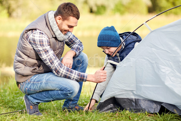 happy father and son setting up tent outdoors Stock photo © dolgachov