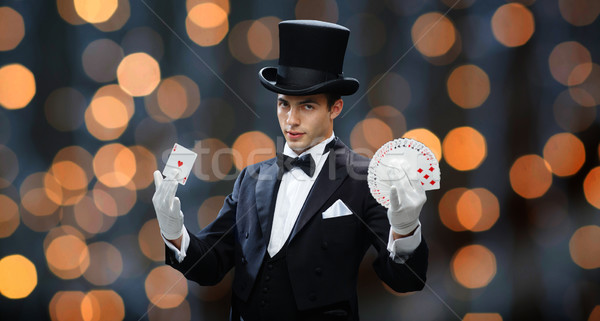 magician showing trick with playing cards Stock photo © dolgachov