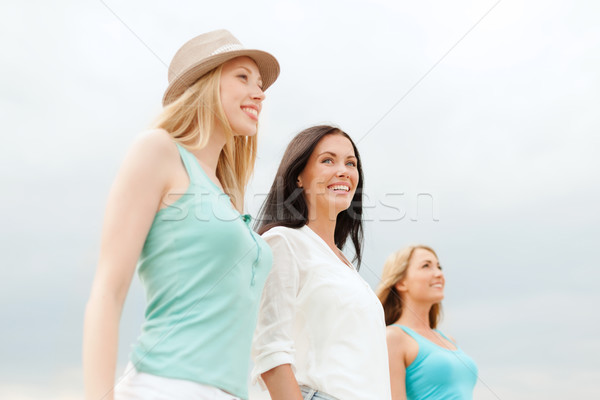 group of smiling girls chilling on the beach Stock photo © dolgachov