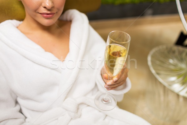 close up of young woman drinking champagne at spa Stock photo © dolgachov