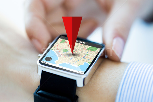 close up of hands with map on smartwatch screen Stock photo © dolgachov