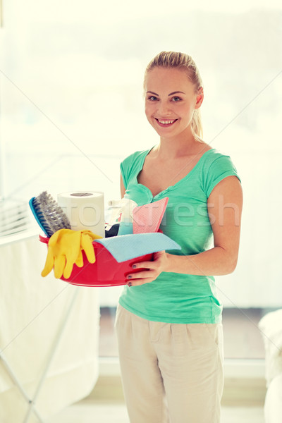 happy woman holding cleaning stuff at home Stock photo © dolgachov