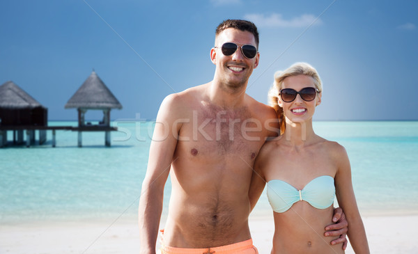 happy couple in swimwear hugging on summer beach Stock photo © dolgachov