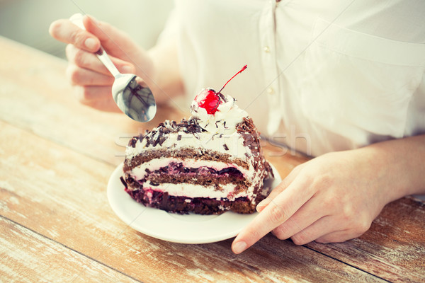 close up of woman eating chocolate cherry cake Stock photo © dolgachov