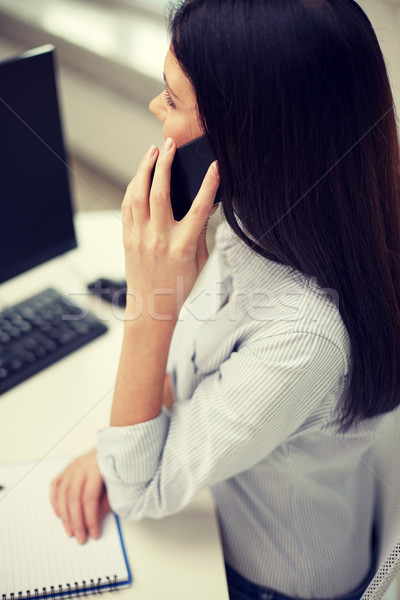 close up of woman talking on smartphone at office Stock photo © dolgachov