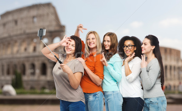 group of happy women taking selfie over coliseum Stock photo © dolgachov