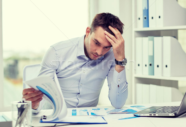 stressed businessman with papers at office Stock photo © dolgachov