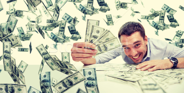 happy businessman with heap of money Stock photo © dolgachov