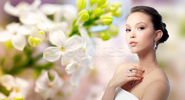 beautiful woman with earring, ring and pendant Stock photo © dolgachov