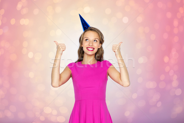 happy young woman or teen girl in party cap Stock photo © dolgachov