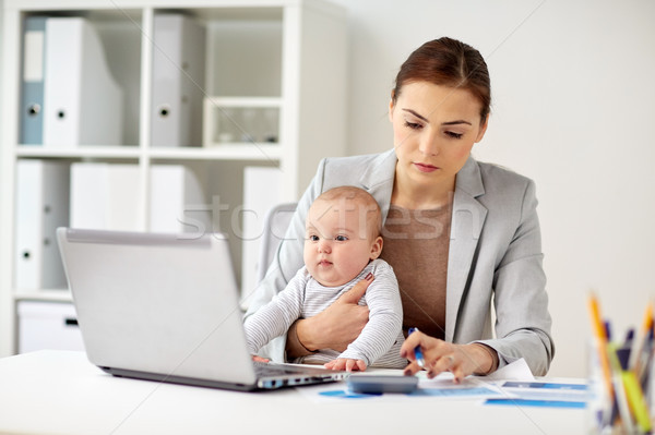 businesswoman with baby working at office Stock photo © dolgachov
